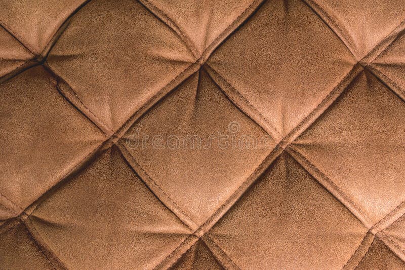 A Closeup of a Fragment of an Expensive Brown Textile Sofa in the Room