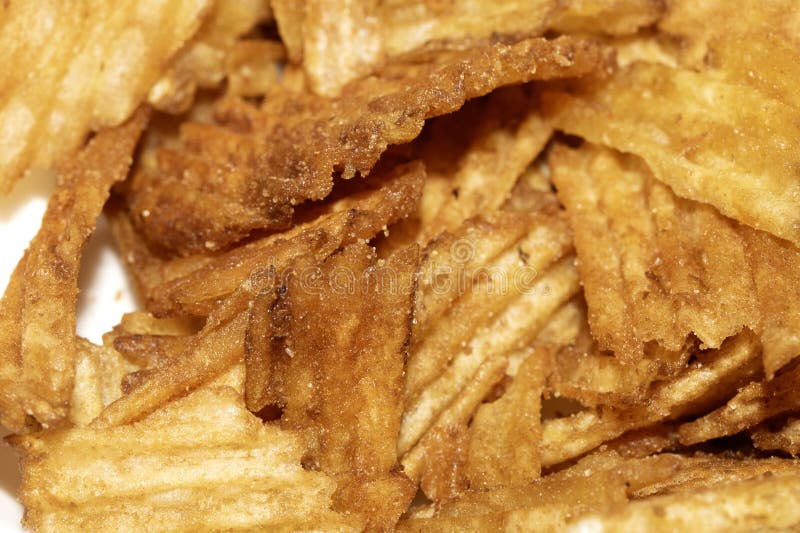 Close up of fresh crinkle cut seasoned crisps snack stock photography