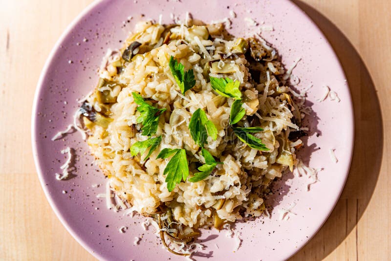 Artichoke risotto is a traditional staple of italian cuisine, prepared with organic ingredients. Artichoke risotto is a traditional staple of italian cuisine, prepared with organic ingredients