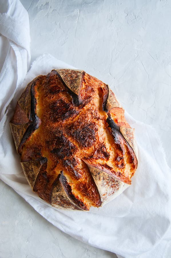 Close Up of Freshly Baked Sourdough Bread on a White Stone Background