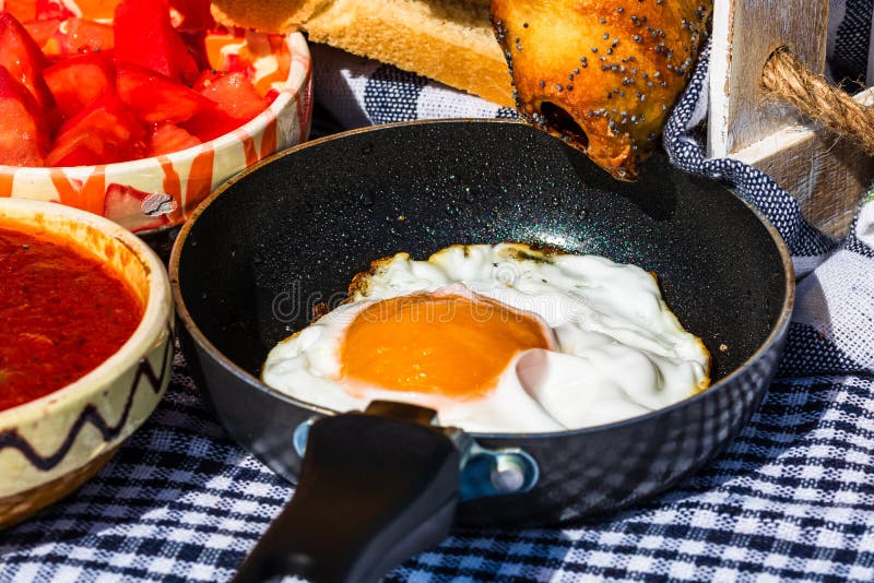 Close Up of Fried Egg in a Small Frying Pan Isolated in a Rustic