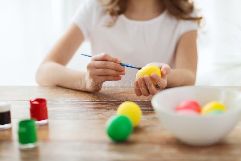 Close up of girl coloring eggs for easter