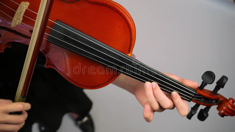 Close Up Of Girl Hands Playing on Violin. Girl Playing Violin. Violinist playing. Musical theme.