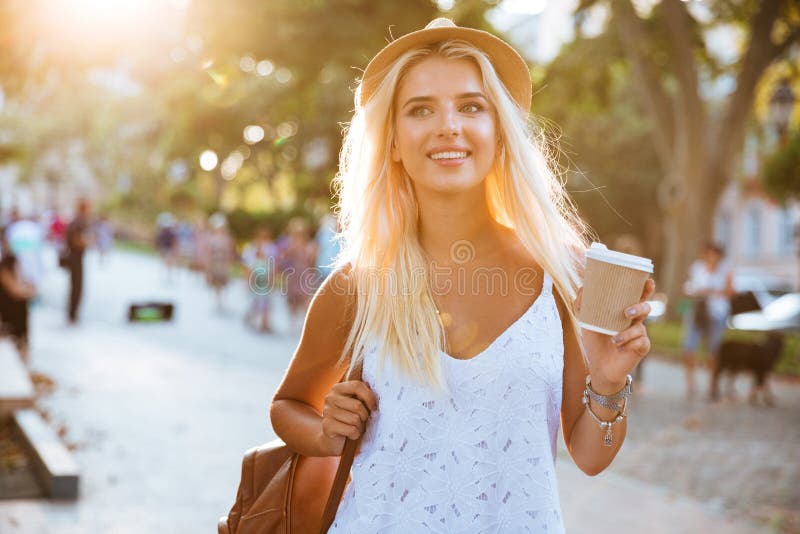 Close up of girl in hat holding take away cup