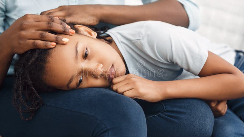 Close-up of black girl`s head laying on lap