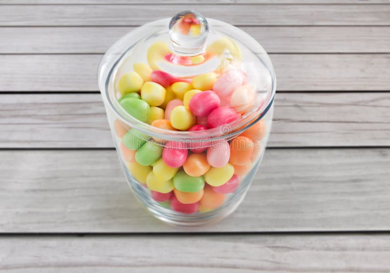 Close up of glass jar with colorful candy drops