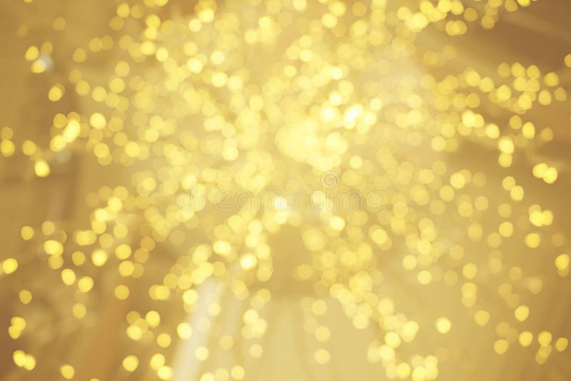 Gold bokeh sparkle glitter from light bulb abstract patterns for Christmas and Happy new year background