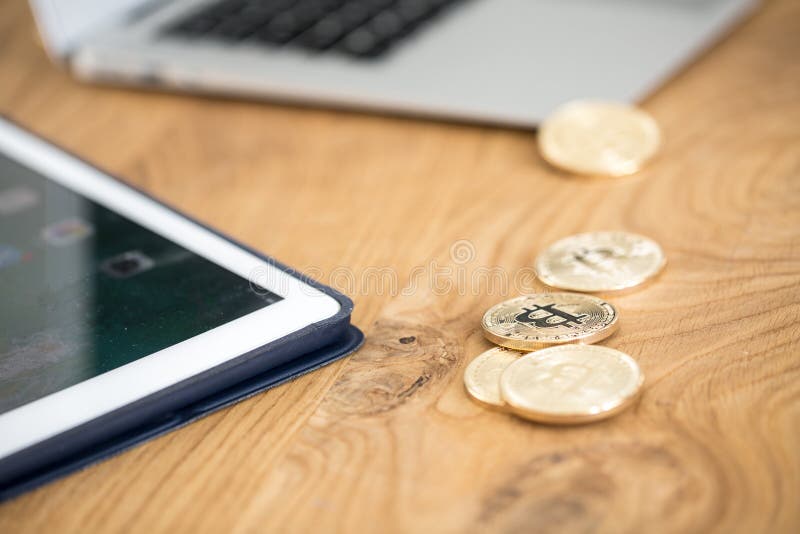 Close-up of gold cryptocurrency coins on table. Investing on the stock photo Close-up of gold cryptocurrency coins on table. Investing on the stock photo