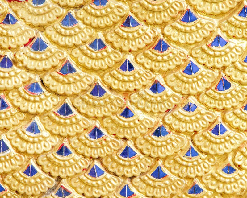 Gold serpent scale statue patterns or colorful naga texture abstract for background stock image