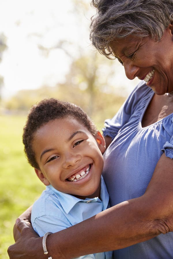 Close Up Of Grandson Hugging Grandmother In Park stock photography Close Up Of Grandson Hugging Grandmother In Park stock photography