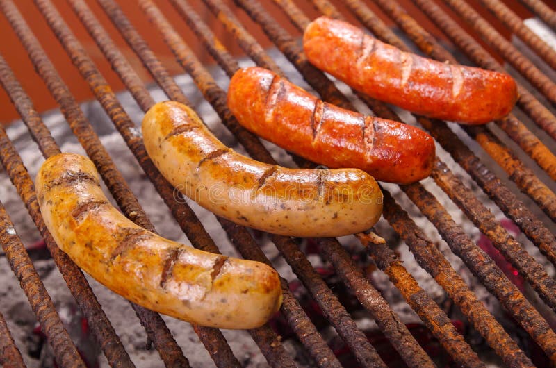 Close up of grilling sausages on barbecue grill. BBQ in the garden. Bavarian sausages royalty free stock image Close up of grilling sausages on barbecue grill. BBQ in the garden. Bavarian sausages royalty free stock image