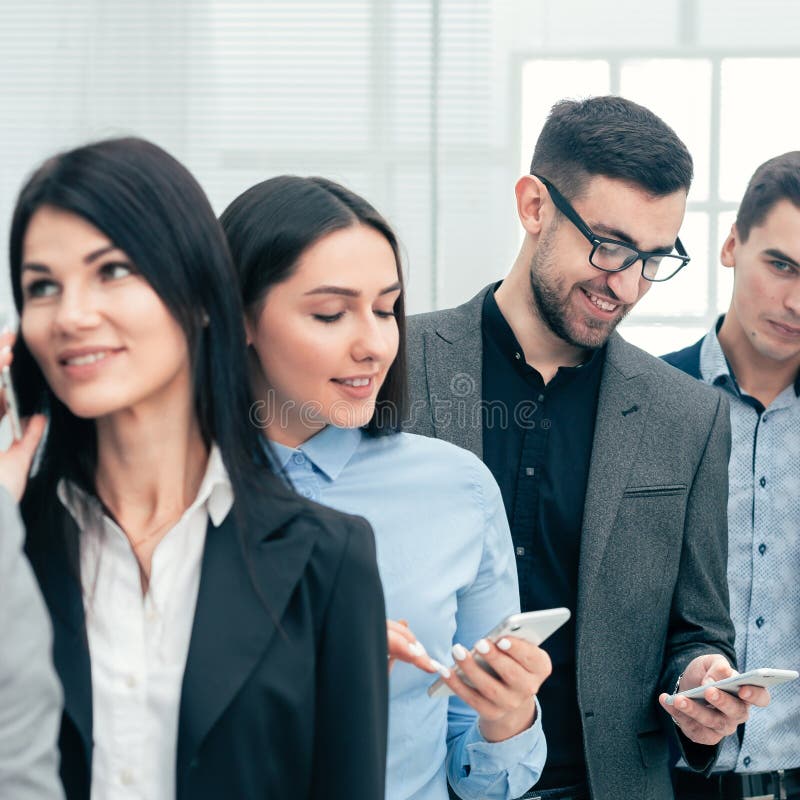 Group of diverse business people using their smartphones stock photo Group of diverse business people using their smartphones stock photo