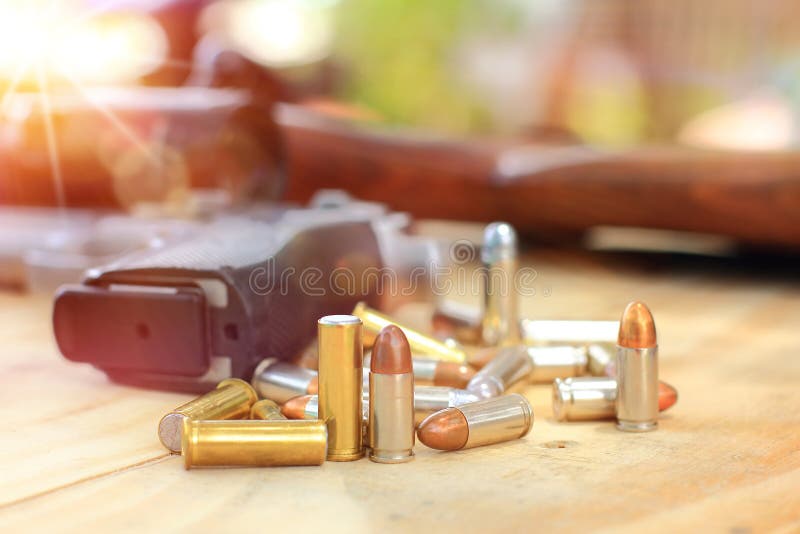 Close up group in flare light and pistol with bullet on table wooden for outdoor sport and hunting royalty free stock photos Close up group in flare light and pistol with bullet on table wooden for outdoor sport and hunting royalty free stock photos