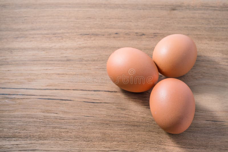 \'Close up group three of Egg on wooden background, isolated, fresh egg I stock photos
