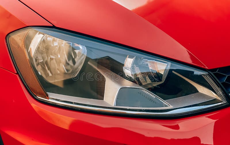 Closeup of Halogen Car Headlights on a Red Car. Car Details Stock