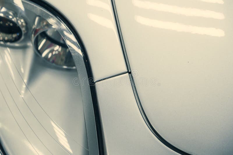 Closeup Halogen Headlight of White Retro Car. Car in the Garage Stock