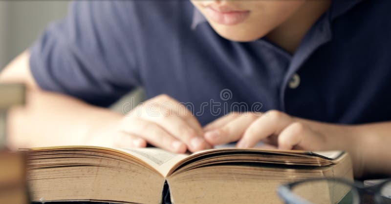 Close up hand of asian boy reading a book . royalty free stock images Close up hand of asian boy reading a book . royalty free stock images