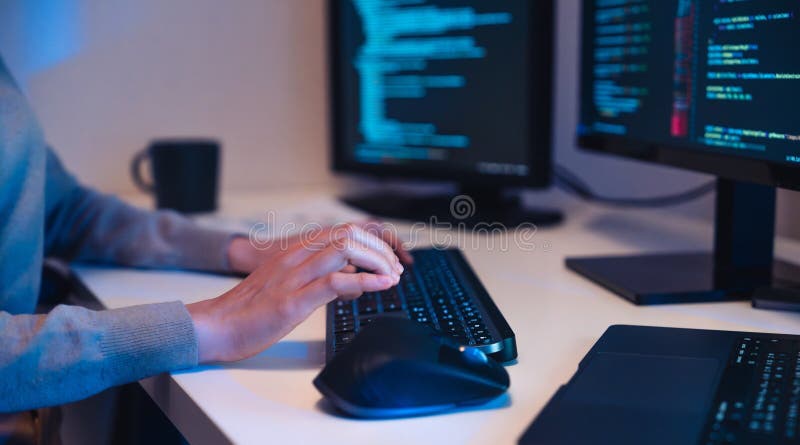 Close up hand of Asian prompt engineer develop coding app with software data sitting in front of computer monitor at office royalty free stock images