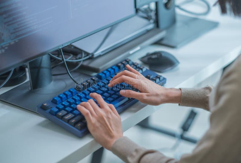 Close up hand of Asian promt engineer develope coding app with software data sitting in front of computer monitor at office stock images