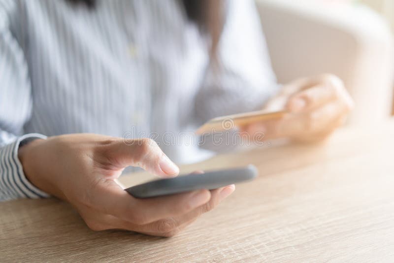 Close up hand of Asian women are buying online with a credit card. woman are using a smartphone and doing online transactions,. Concept of shopping on the royalty free stock images Close up hand of Asian women are buying online with a credit card. woman are using a smartphone and doing online transactions,. Concept of shopping on the royalty free stock images