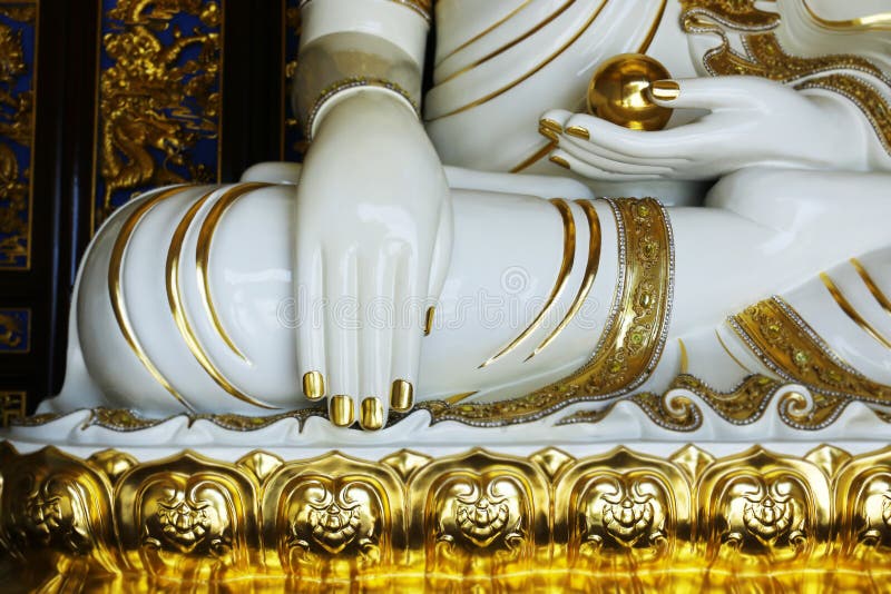 Close up of hand of buddhist statue stock photos.