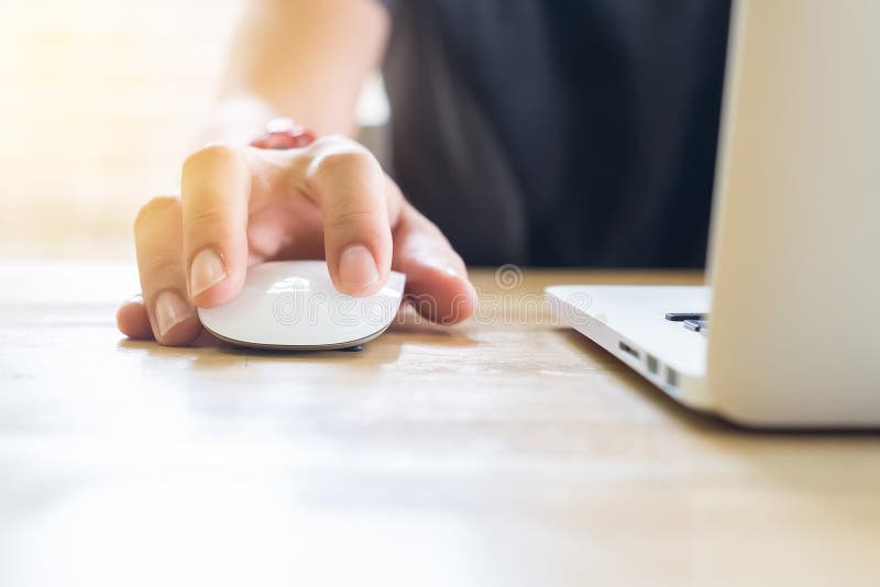 close up hand business man using mouse and laptop in office with