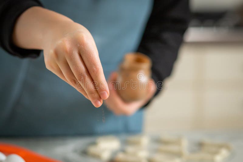 Close-up on the Hand of a Cook Sprinkling Spices from a Jar while ...