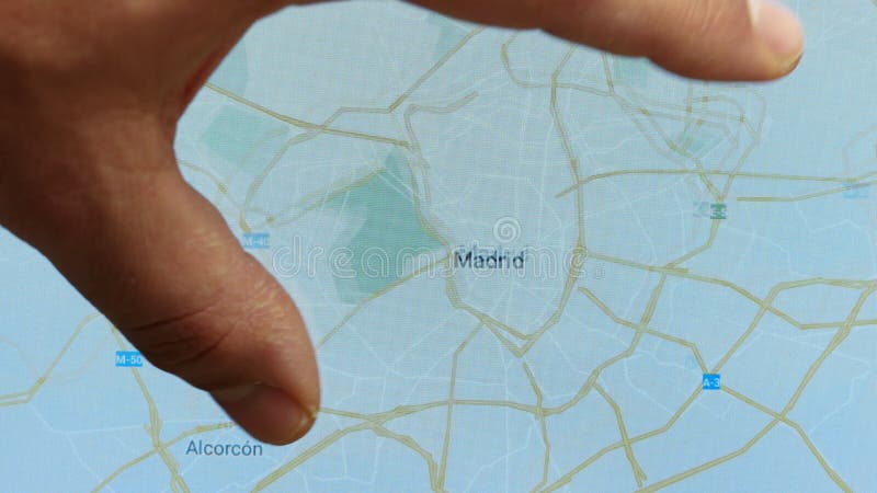 Close up hand gesture on touch screen zoom in madrid city Spain stock video footage