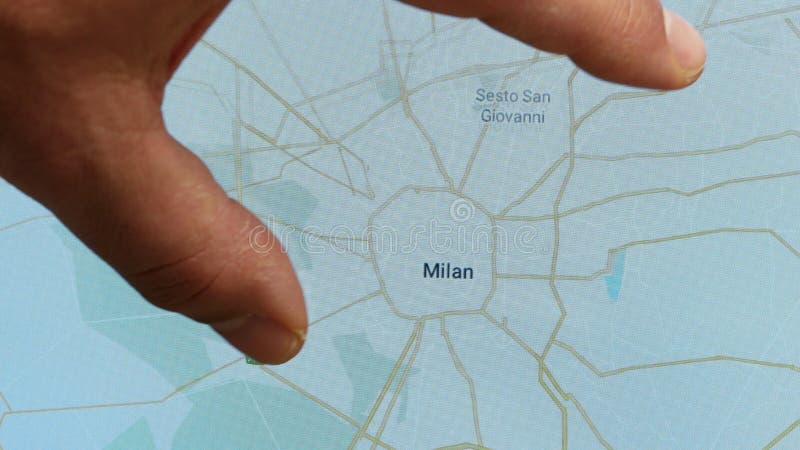 Close up hand gesture on touch screen zoom in Milan city Italy stock footage