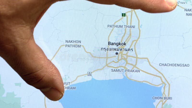 Close up hand gesture on touch screen zooming in Bangkok city stock video