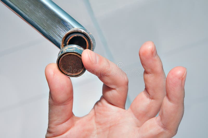 Close Up Of Hand Handyman Repairing A Faucet In The Bathroom