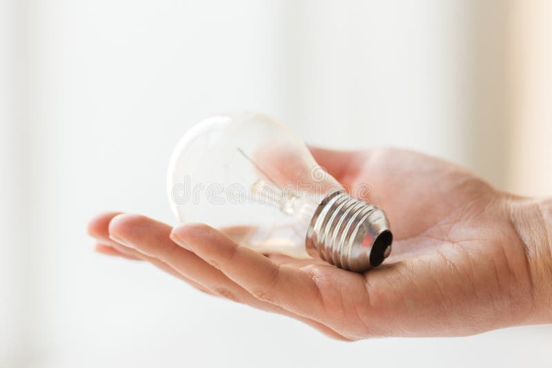 Close up of hand holding edison lamp or lightbulb royalty free stock photography Close up of hand holding edison lamp or lightbulb royalty free stock photography