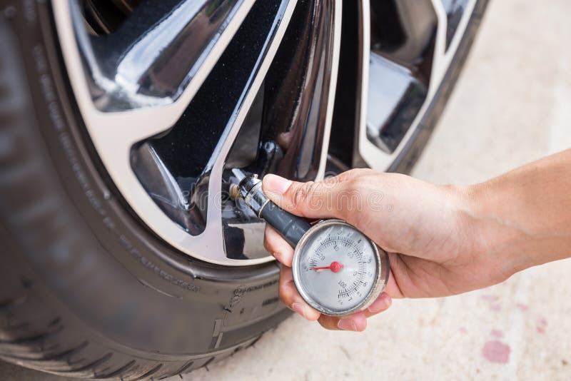 Close-Up Of Hand holding pressure gauge