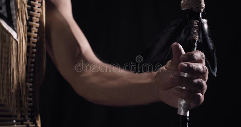 Close up of a hand holding a spear, indian traditional costume, tribe, 4k