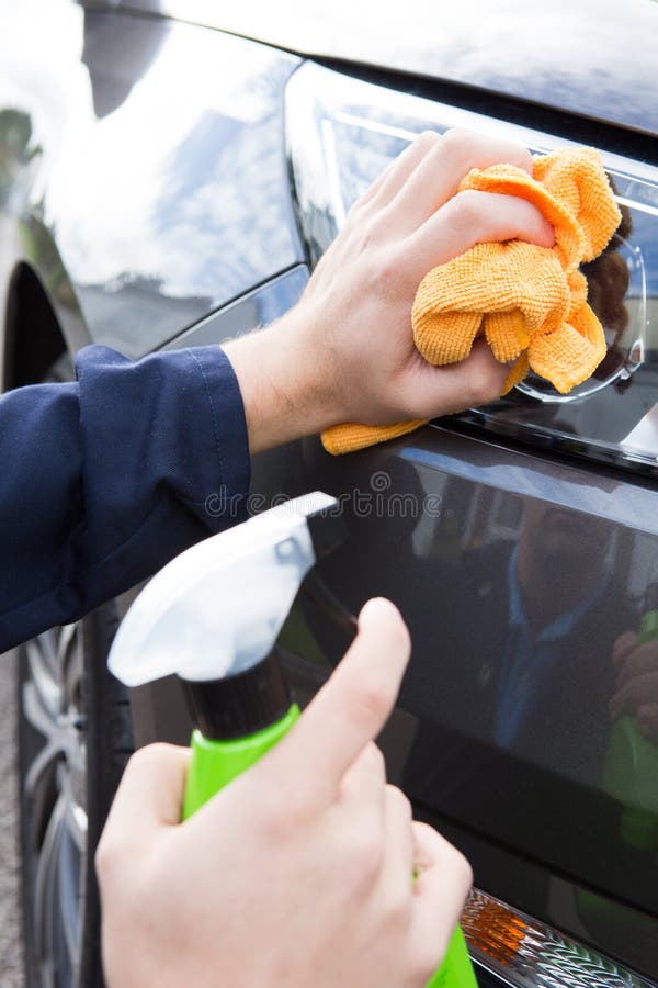 Close Up of Hand Polishing Car Headlight Using Cloth Stock Photo