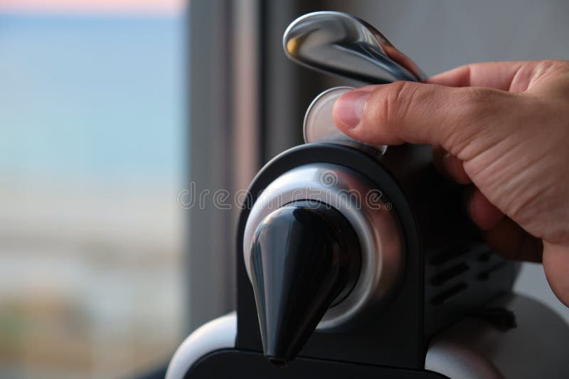 Close up of a hand preparing coffee in a coffee machine with capsules. royalty free stock images
