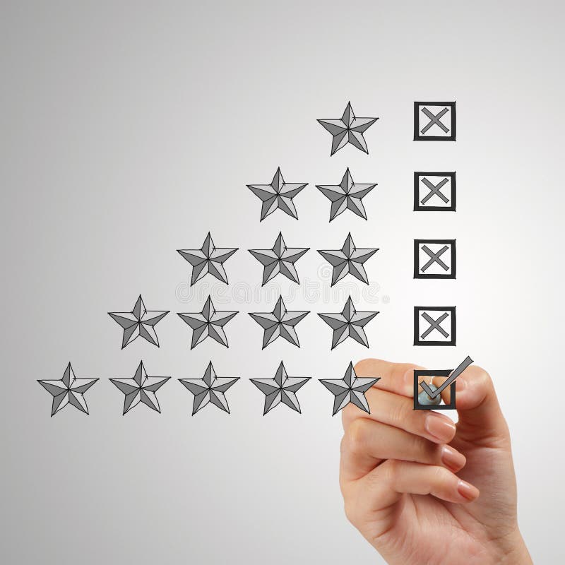 Close up of hand putting check mark on five star rating stock photo