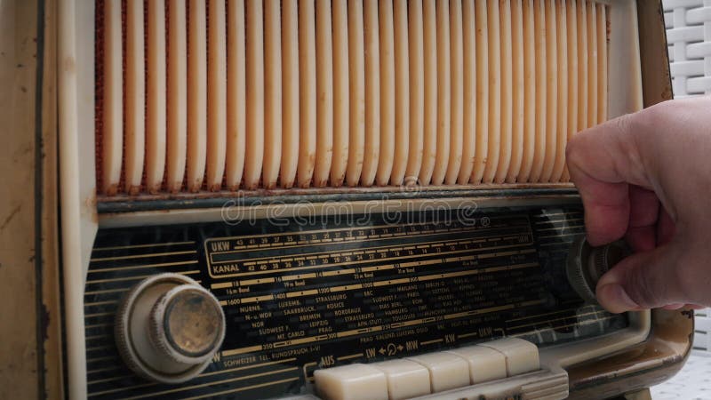 Close up hand tuning radio button on vintage radio stock video