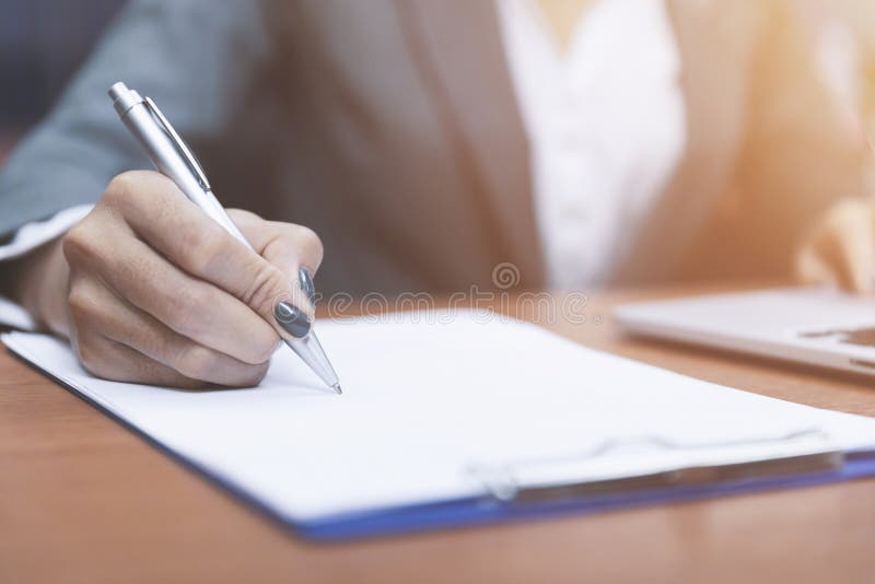 Close up hand of woman holding pen thinking and writing data or business planning in paper for remember and learn,Writing royalty free stock images