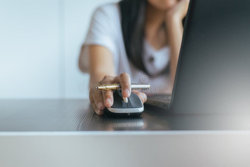 Close up of hand woman serching and click mouse using laptop stock photos Close up of hand woman serching and click mouse using laptop stock photos