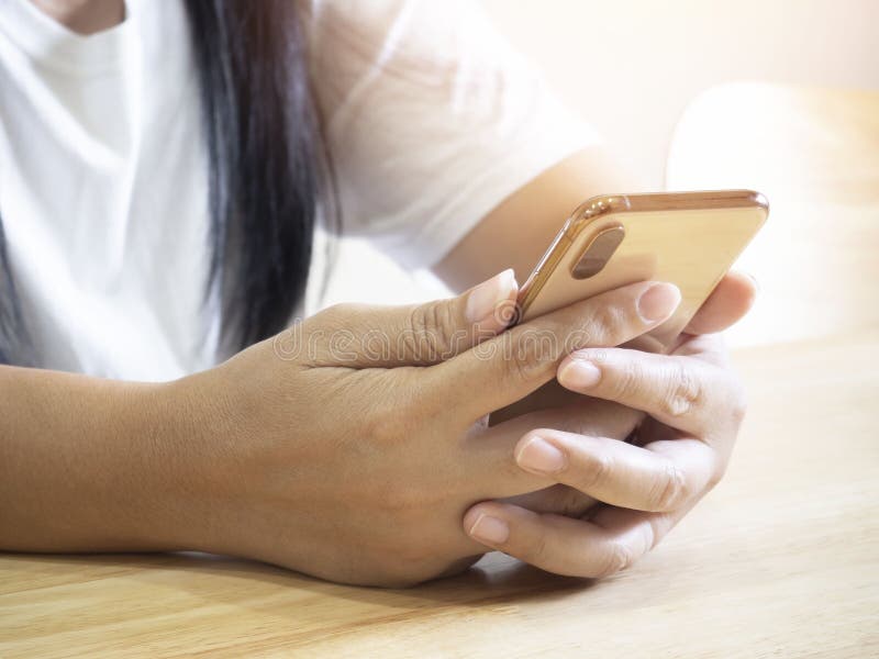 Close up hand of woman using smartphone at home royalty free stock image