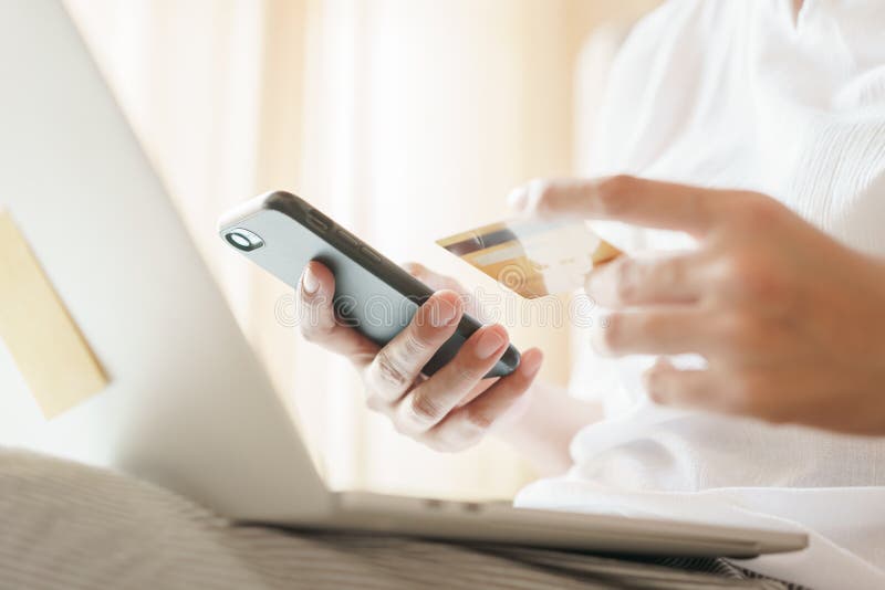 Close up hand of women are buying online with a credit card. woman are using smartphone and doing online transactions. stock photo Close up hand of women are buying online with a credit card. woman are using smartphone and doing online transactions. stock photo