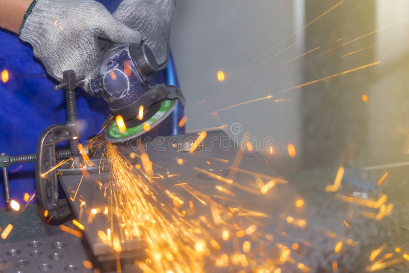 Close Up Hand Worker and Electric Wheel Grinding Machine and Spark