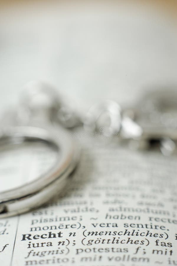 Close Up of Handcuffs on Dictionary Stock Photo Image of handcuff