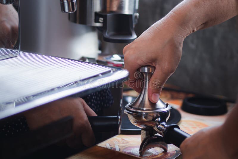 Closeup of Hands Barista Presses Ground Coffee Using a Tamper. the Process of Making Coffee