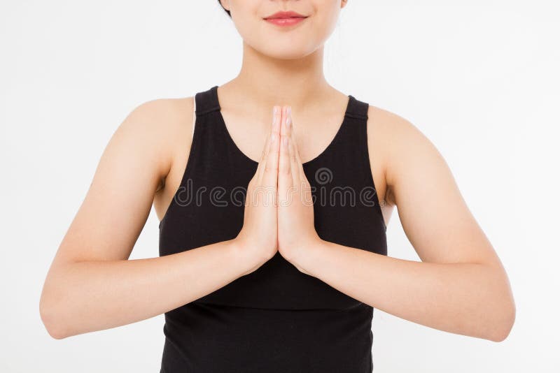 Close-up of hands of black woman in white clothes meditating indoors, focus on arms in Namaste gesture.Mock up. Copy space. Template. Blank