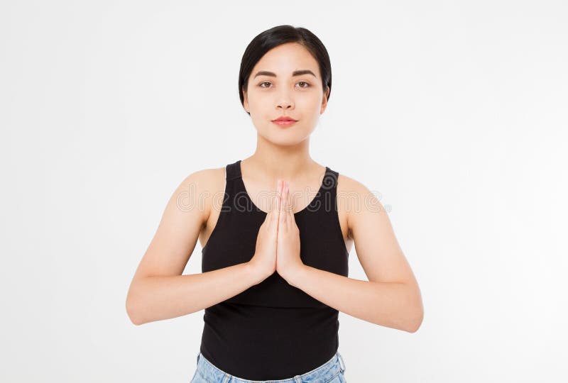 Close-up of hands of black woman in white clothes meditating indoors, focus on arms in Namaste gesture.Mock up. Copy space. Template. Blank