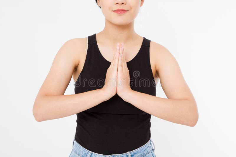 Close-up of hands of black woman in white clothes meditating indoors, focus on arms in Namaste gesture.Mock up. Copy space. Template. Blank