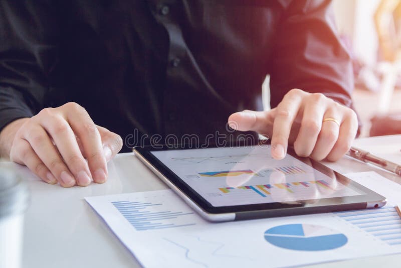 Close up hands business man in black shirt using tablet, point to discuss, plan and chart the rise and fall of the economy royalty free stock photo Close up hands business man in black shirt using tablet, point to discuss, plan and chart the rise and fall of the economy royalty free stock photo