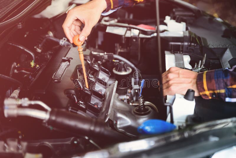 Close up hands checking lube oil level of car engine from deep-stick for service and maintenance concept vintage tone stock photos Close up hands checking lube oil level of car engine from deep-stick for service and maintenance concept vintage tone stock photos